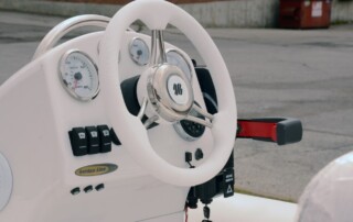 Steering wheel on the GRAND golden line luxury fiberglass rigid inflatable boat (RIB) tender with steering console.