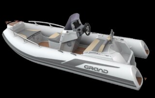 Side view of GRAND Golden line 13’9″ long luxury rigid inflatable boat (RIB) tender in towing mast, steering console, and bow step plate.