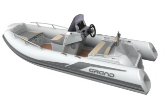 Side corner view of GRAND Golden line 13’9″ long luxury rigid inflatable boat (RIB) tender with towing mast, steering console, and bow step plate.