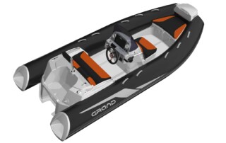 Back corner view of GRAND Golden line 13’9″ long luxury rigid inflatable boat (RIB) tender in black and light grey with orange upholstery, towing mast, steering console, and bow step plate.