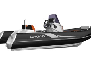 Side view of GRAND Golden line 13’9″ long luxury rigid inflatable boat (RIB) tender in black and light grey with orange upholstery, towing mast, steering console, and bow step plate.