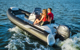 Boating in a GRAND Golden line 13’9″ long luxury rigid inflatable boat (RIB) tender; fiberglass hull, yamaha 70hp outboard motor, steering console, and bow step plate.