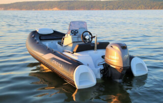 GRAND Golden line 13’9″ long luxury rigid inflatable boat (RIB) tender in black; fiberglass hull, yamaha 70hp outboard motor, steering console, and bow step plate.