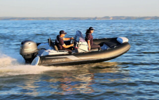 Boating in a GRAND Golden line 13’9″ long luxury rigid inflatable boat (RIB) tender in black; fiberglass hull, yamaha 70hp outboard motor, steering console, and bow step plate.