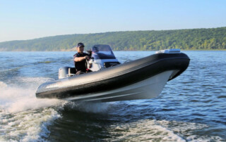 Boating in a GRAND Golden line 13’9″ long luxury rigid inflatable boat (RIB) tender in black; fiberglass hull, yamaha 70hp outboard motor, steering console, and bow step plate.