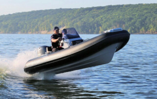 Boating in a GRAND Golden line 13’9″ long luxury rigid inflatable boat (RIB) tender in black; fiberglass hull, yamaha 70hp outboard motor, steering console, and bow step plate.