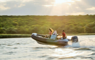 Boating in a GRAND Golden line 13’9″ long luxury rigid inflatable boat (RIB) tender in black; fiberglass hull, yamaha 70hp outboard motor, steering console, and bow step plate.