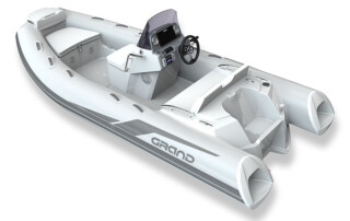 Back corner view of the GRAND Golden line 13’9″ long luxury rigid inflatable boat (RIB) tender; fiberglass hull, steering console, and bow step plate.
