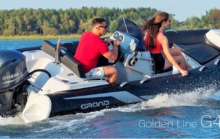 Boating in a GRAND golden line luxury rigid inflatable boat (RIB) tender in black, 13’9″ long.