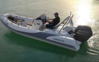 Boating in a GRAND golden line 16’3″ long luxury rigid inflatable boat (RIB) in white & dark gray with a fiberglass hull.