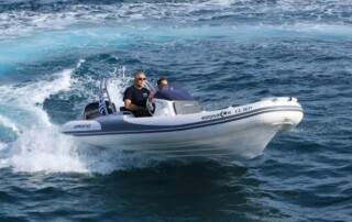 Boating in a GRAND golden line 16’3″ long luxury rigid inflatable boat (RIB) in black & white with a fiberglass hull.