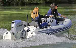 GRAND GOLDEN LINE 10′ 10” fiberglass RIB tender equipped with seating, steering console, & towing mast.