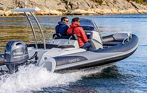 GRAND GOLDEN LINE 19′ 2” fiberglass rigid inflatable boat (RIB) equipped with towing/navigation arch, handrails, step ends, seating, and steering console.